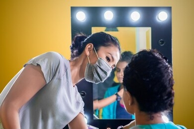picture of young makeup artist preparing her model before photoshoot by applying visage makeup