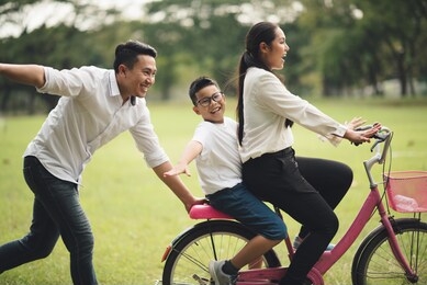 family asian summer holiday in garden. group of asia family enjoyed playing at the park.