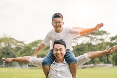 asian family summer holiday in garden. group of asia family enjoyed playing at the park. portrait son boy hugging father, cheerful relationship at home garden happiness.