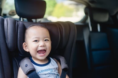 transport, safety, childhood road trip and people concept - happy baby boy sitting in baby car seat or booster seat, child in auto baby seat in car, asian boy in summer vacation to travel with family.