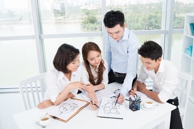 group of businesspeople brainstorming at office