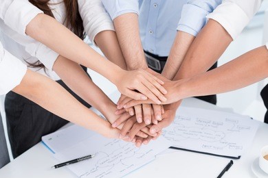 closeup of people's hands working together