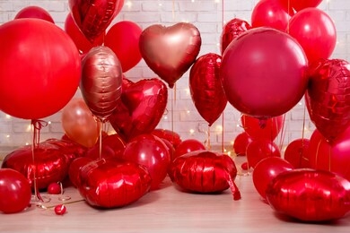 valentine's day background - group of red circle and heart shaped balloons