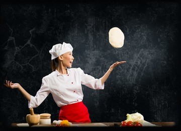 asian female chef tosses a piece of dough, creative cooking