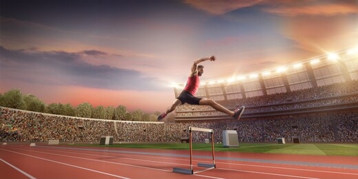 male track and field athlete jumps over the barrier at the running track in professional stadium