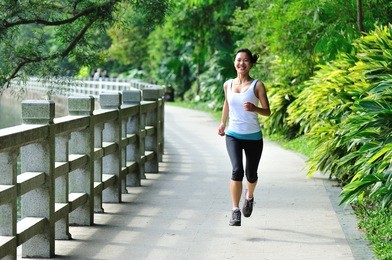 young asian woman jogging in park