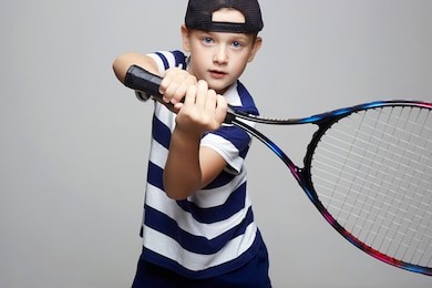 little boy playing tennis. sport kids. child with tennis racquet