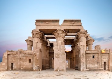 ruins of the temple of kom ombo in the nile river at sunset, egypt