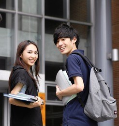 couple college student sitting holding laptop on campus