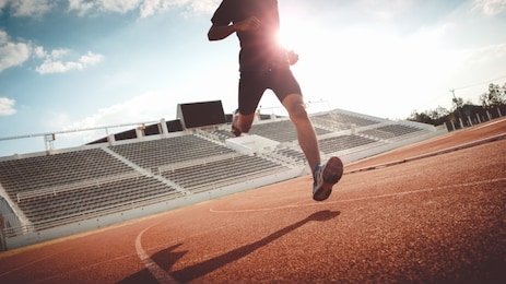 sport backgrounds, male runner ready for sports exercise, athlete running on athletic track.