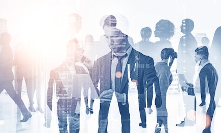 team of diverse managers working with gadgets and documents over foggy cityscape background. concept of teamwork. toned image double exposure