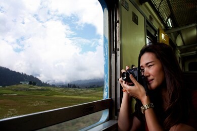 ฺbeautiful asian woman makes a photo through from the train window