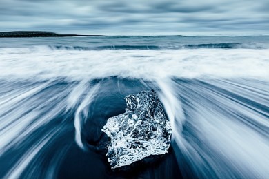 incredible piece of the iceberg sparkle on black sand. location jokulsarlon lagoon, diamond beach, vatnajokull national park, iceland, europe. popular tourist attraction. discover the beauty of earth.