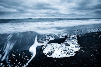 incredible piece of the iceberg sparkle on black sand. location jokulsarlon lagoon, diamond beach, vatnajokull national park, iceland, europe. popular tourist attraction. discover the beauty of earth.