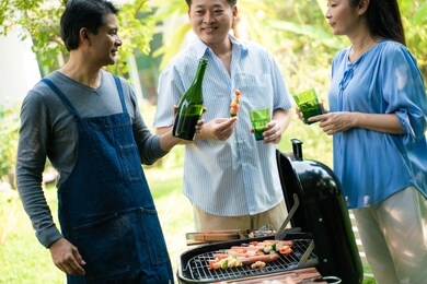 group of asian senior early retirement party in green park outdoor bbq food and drink