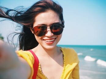happy young asian woman selfie herself by the sea,traveler concept.