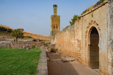 sunset  in atmospheric chellah necropolis, with the minaret and the walls on the background.
rabat, morocco.