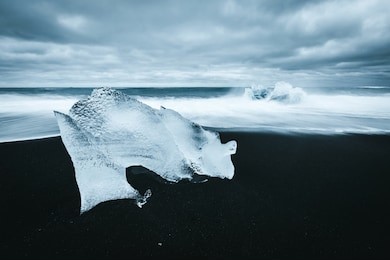 incredible piece of the iceberg sparkle on black sand. location jokulsarlon lagoon, diamond beach, vatnajokull national park, iceland, europe. popular tourist attraction. discover the beauty of earth.