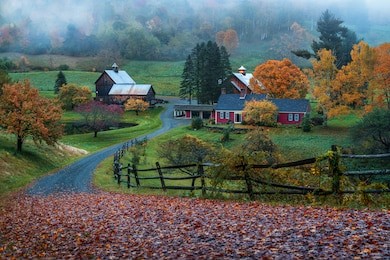 iconic vermont farmstead sleepy hollow on a foggy dusky evening in autumn with fall foliage 