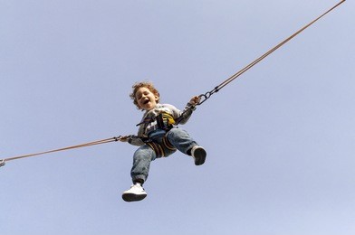 boy jumping on trampoline