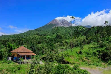 view of mount merapi on the sunny morning from hill of klangon, yogyakarta indonesia
