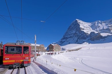 the jungfrau railway train station at kleine scheidegg leading to jungfraujoch, peak and the famous north face of mount eiger in the background, bern, switzerland, europe