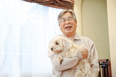 senior holding her dog