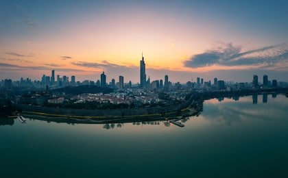 skyline of nanjing city at sunset. image taken with a drone flying over xuanwu lake.