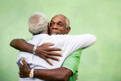 active retired old men and leisure, two senior black brothers hugging outdoors