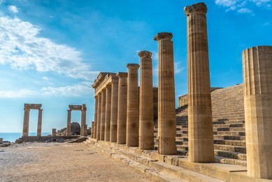 antique pillars of a beautiful acropolis of lindos on the island of rhodes, greece.