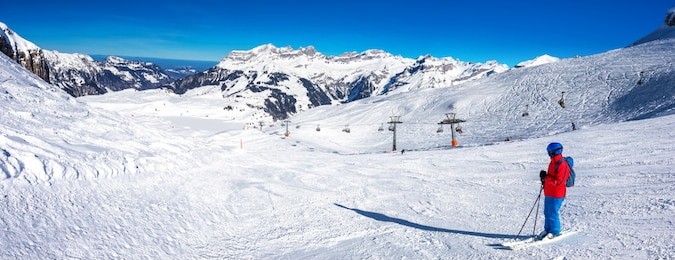 beautiful winter landscape with swiss alps. skiers skiing in famous engelgerg - titlis ski resort, switzerland, europe. 