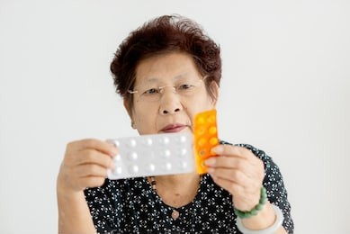 asian senior woman showing medicines in her hands, lifestyle concept.
