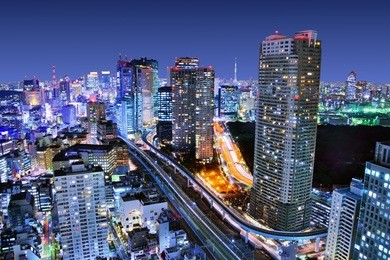 dense buildings in minato-ku, tokyo japan with tokyo sky tree visible on the horizon.