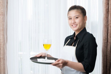 portrait of a smiling waitress looking at camera