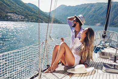 loving couple spending happy time on a yacht at sea. luxury vacation on a seaboat. 