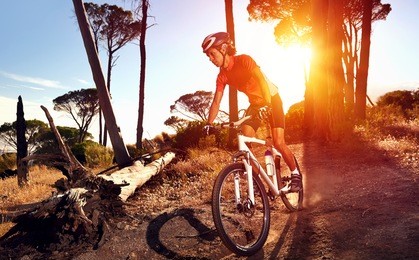 mountain bike cyclist riding single track at sunrise healthy lifestyle active athlete doing sport
