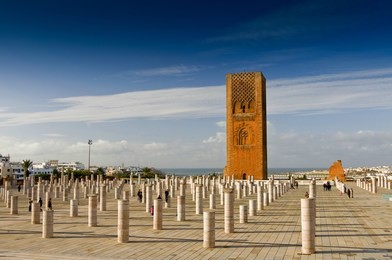 tour hassan tower in the square with stone columns. made of red sandstone, important historical and tourist complex in rabat, morocco.