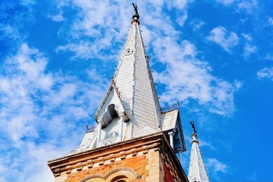 tower of notre dame cathedral basilica in ho chi minh city in vietnam in asia. former vietnamese town called saigon. cityscape with church and blue sky on background