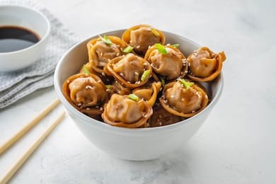 fried dumplings with soy sauce with pepper and green onions. asian cuisine. copy space.