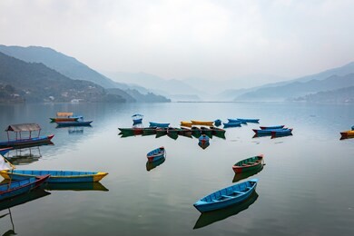 floating boats on phewa lake of pokhara, nepal