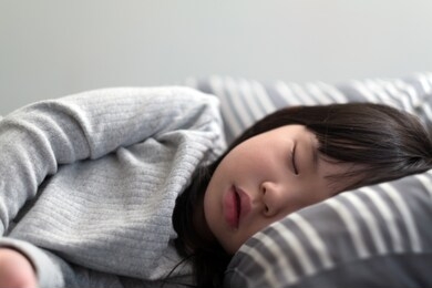 asian child girl sleeping on the bed in her bedroom