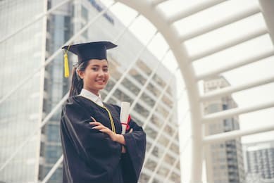 graduate student and success education in university concept. happy asian student woman graduate diploma and mba degree in asian college