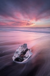beautiful sunset over famous diamond beach, iceland. this sand lava beach is full of many giant ice gems, placed near glacier lagoon jokulsarlon ice rock with black sand beach in southeast iceland