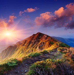 beautiful summer sunrise in mountains. path along the ridge leading to summit