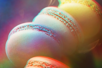 colorful macarons on dark blue background with 3d effect. top view, close up.