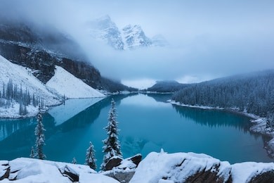 first snow morning at moraine lake in banff national park alberta canada snow-covered winter mountain lake in a winter atmosphere. beautiful background photo concept