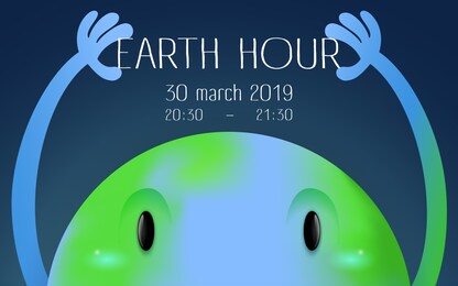 earth hour banner with a big looking earth character holding words earth hour on a dark blue space background