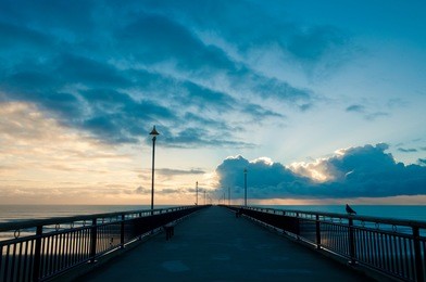 fantastic sunrise over pacific ocean at new brighton pier, christchurch, new zealand
