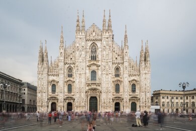 photography of duomo di milano cathedral with lots of motion blurred hurrying people and tourists.