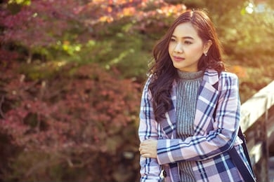 portrait of young asian girl in autumn park